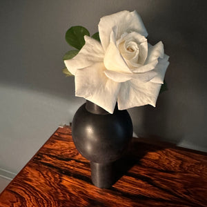 M+A NYC KEYHOLE VASE IN SOAPSTONE WITH A WHITE ROSE ON A VINTAGE ZEBRAWOOD TABLE