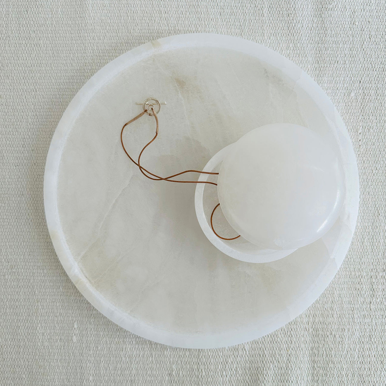 M+A NYC Alabaster Round Tray with Lens Box sitting on top