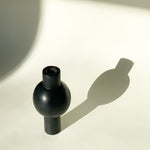 Image of M+A NYC Black Soapstone Keyhole Vase basking in the late afternoon light.