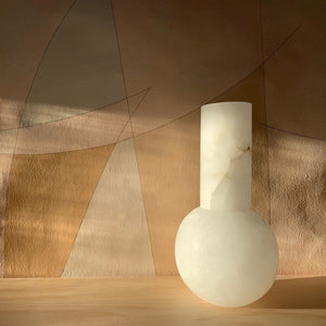 M+A NYC Lolita Vase in alabaster basking in the late afternoon sun, against wallpaper by Fromental Design.