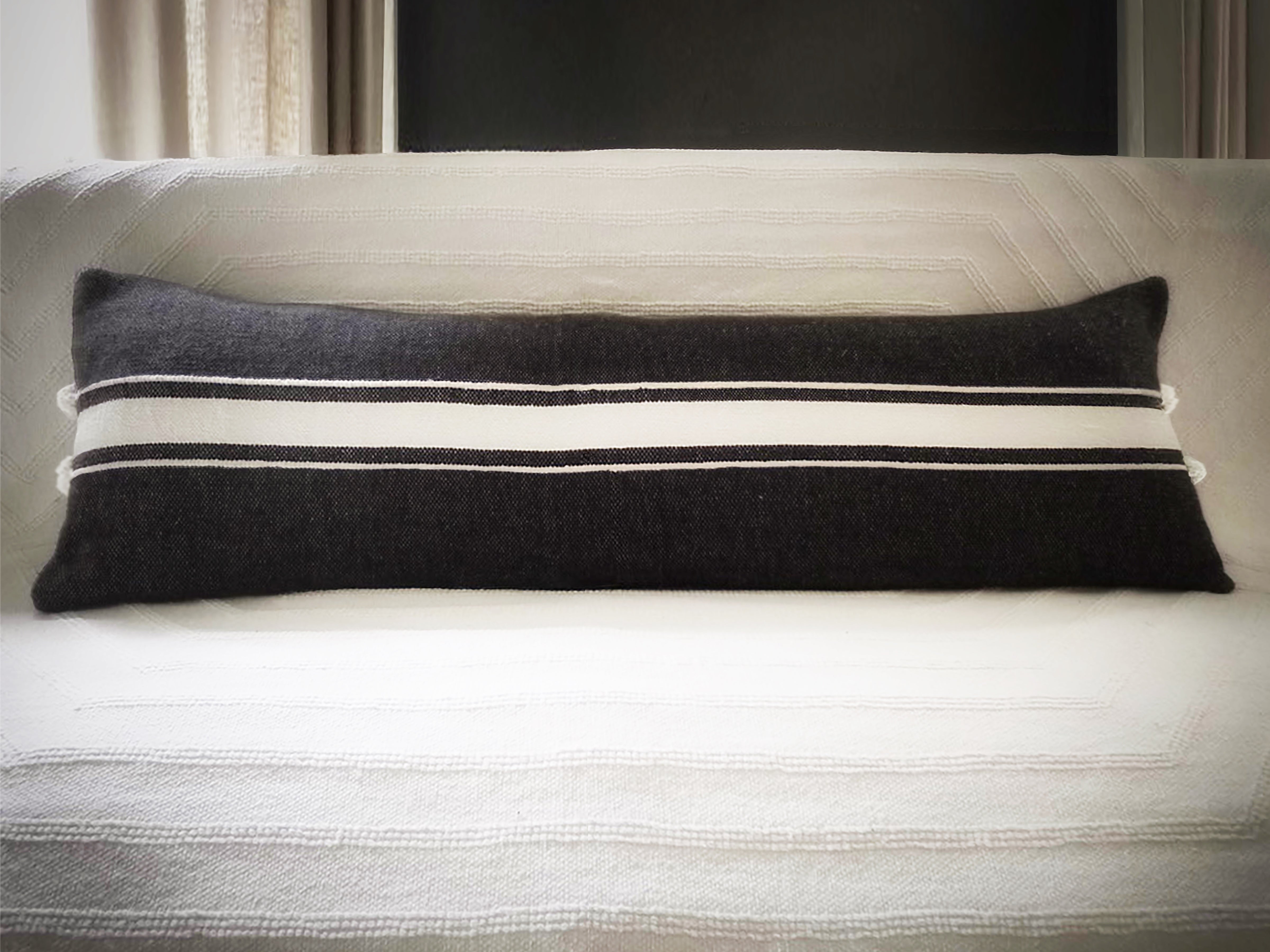 Image of Ribbon Striped X-tra Long Lumbar Pillow on a couch with the Stella Throw in Kora.