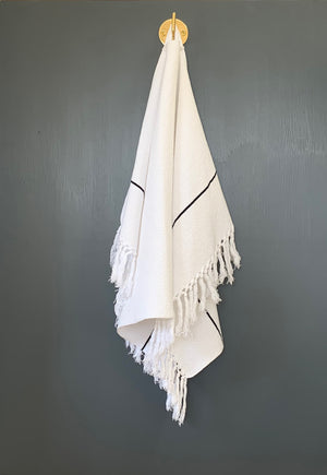 Image of M+A NYC Hand Loomed Honeycomb Hand Towel hanging from our Solid Brass Wall Hook that is 1 3/4" long.