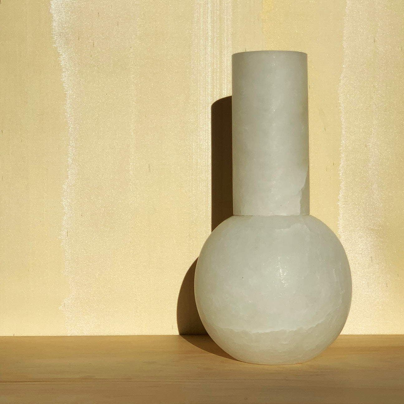Image of M+A Lolita Vase basking in the early evening light and sitting in front of wallpaper by Fromental Design