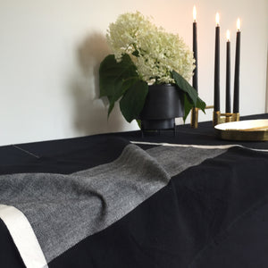 Image of a tablescape by M+A NYC with an open Colorblock Napkin in Black and Kora