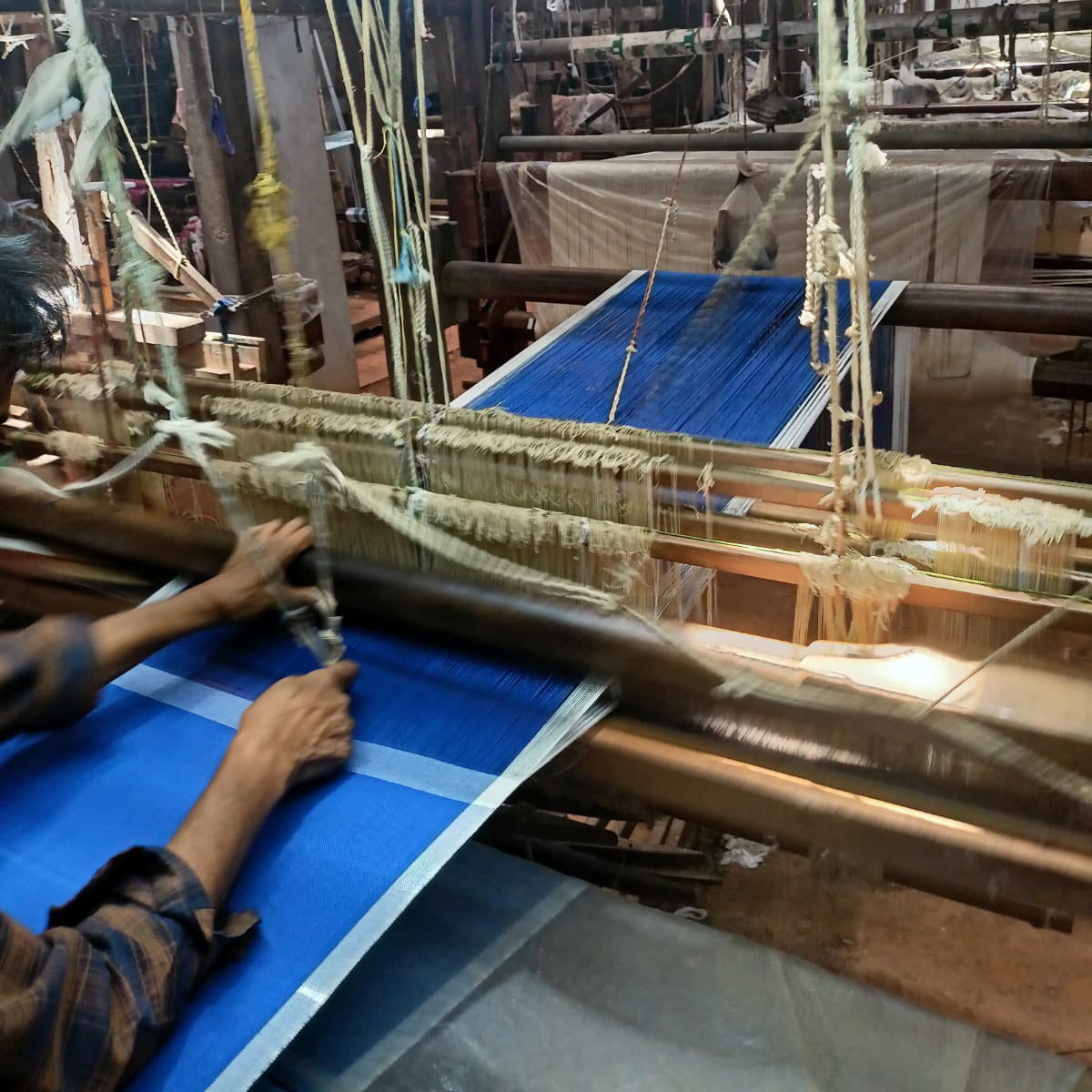Image of M+A Colorblock Napkins in the colorway Perfect Day/Kora being woven on a wooden handloom.