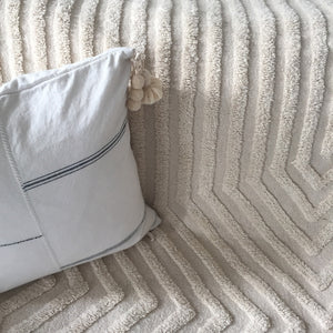 Image of M+A NYC Handloomed Offset Stripe 18" Pillow, featuring pom pom and tassel detail at one of the top corners.